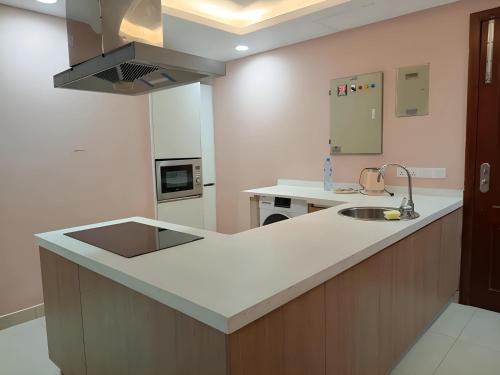 a kitchen with a sink and a counter top at Gold Crest Premium Hotel Serviced Apartments DHA Phase 4 Lahore in Lahore