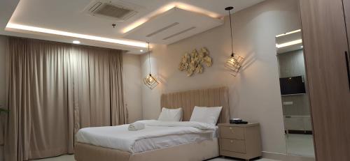 a hotel room with a bed and a mirror at Gold Crest Premium Hotel Serviced Apartments DHA Phase 4 Lahore in Lahore