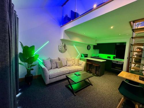 a living room with a couch and a table at Boutique Spa apartment with Balcony & River Views in Norwich
