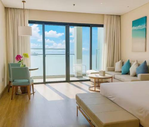 a living room with a couch and a large window at Home tai gia in Quy Nhon