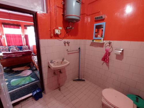 a bathroom with a toilet and a sink at Homestay Blue Horizon in Darjeeling