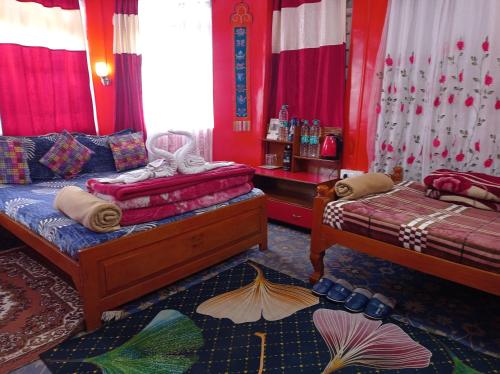 two beds in a room with red walls at Homestay Blue Horizon in Darjeeling