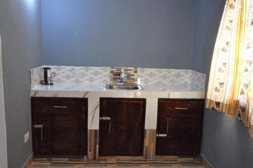 a sink in a bathroom with a counter at Bulu Apartments in Kilifi