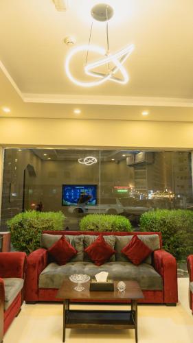 a living room with a couch and a table at PAN Hotel Apartments in Sharjah