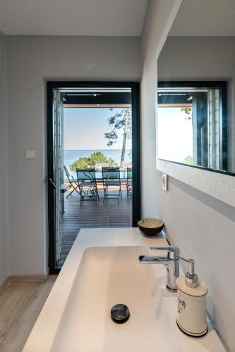 a kitchen with a sink and a view of the ocean at Villa-SONNIER-Biscarrosse in Biscarrosse