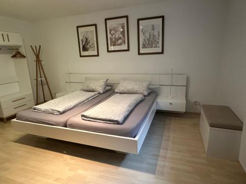 a bedroom with a bed with two pillows on it at Haus Alexandra in Rust