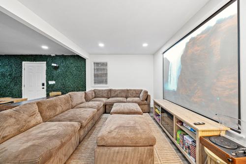 a living room with a large screen tv at 2 King Beds Cozy Athens GA Getaway in Athens