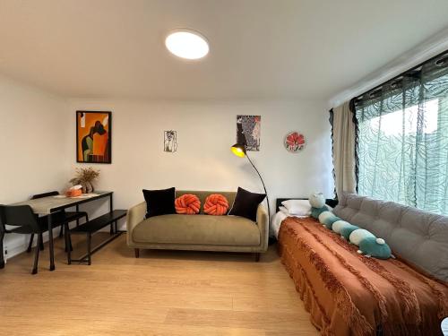 a living room with a couch and a table at Stylish One Bedroom Apartment in Edinburgh