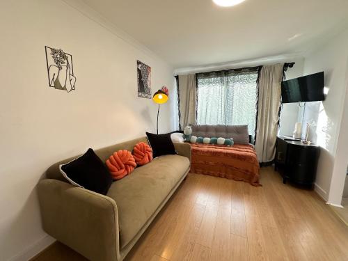 a living room with a couch and a window at Stylish One Bedroom Apartment in Edinburgh