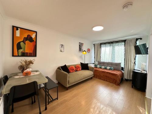 a living room with a couch and a table at Stylish One Bedroom Apartment in Edinburgh