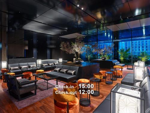 a rendering of a lobby with couches and tables at Mitsui Garden Hotel Nihonbashi Premier in Tokyo