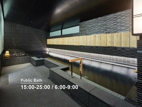 a pool of water in a building with a swimming pool at Mitsui Garden Hotel Nihonbashi Premier in Tokyo