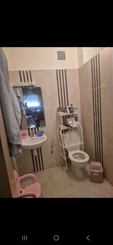 a small bathroom with a toilet and a sink at Gravereau in Oujda