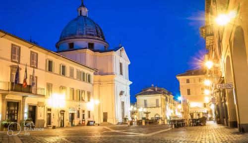 a building with a dome on the top of a street at Residenza dei Papi - Luxury City House in Castel Gandolfo