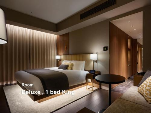 a hotel room with a bed and a couch at Mitsui Garden Hotel Roppongi Tokyo Premier in Tokyo