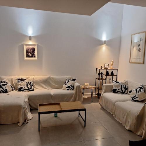 a living room with two couches and a table at Chilches Sunset Beach in Vélez-Málaga