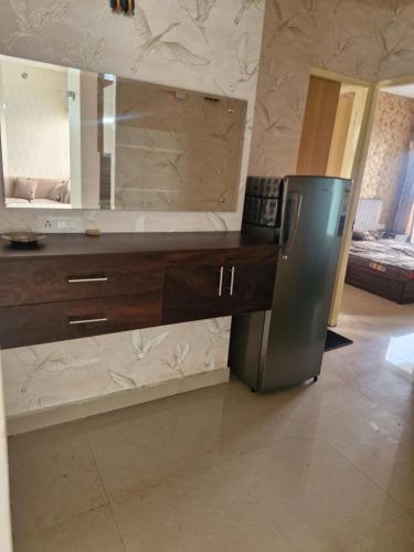 a bathroom with a vanity with a large mirror at My Private Space in Ludhiana