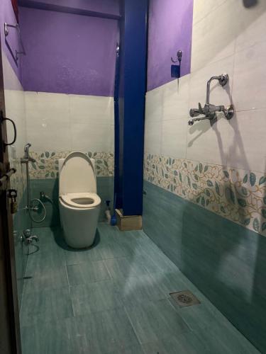 a bathroom with a toilet and a shower at The Kapil Homestay in Manamaiju