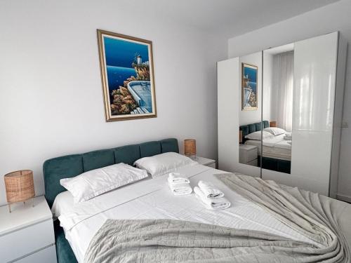 a bedroom with a bed with two towels on it at Sunshine Luxury Apartment Private Parking in Cluj-Napoca
