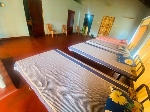 a room with three tables and chairs in a room at Ceylon Grand Airport Tourist Accommodation in Katunayake