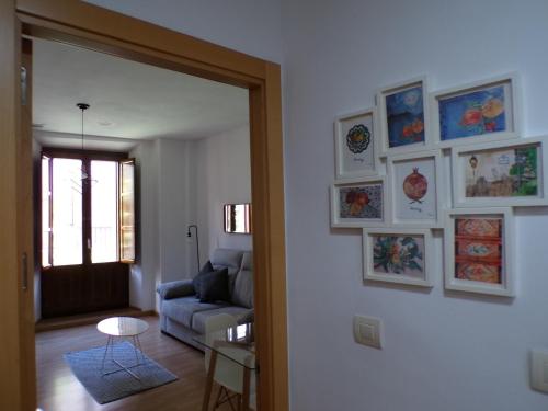 a living room with a couch and pictures on the wall at Rental in the center of Granada 1B in Granada