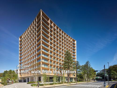 a tall building with a sign that reads walk from the station at Mitsui Garden Hotel Jingugaien Tokyo Premier in Tokyo
