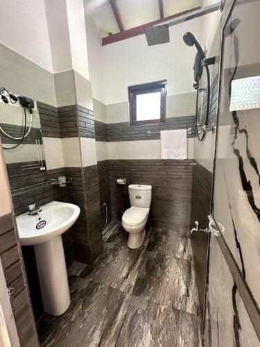 a bathroom with a toilet and a sink at Yasiru Villa in Weligama