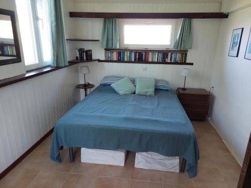 a bedroom with a blue bed with two pillows at Casa Cuculo - Rustico mit traumhaftem Meerblick in Scansano