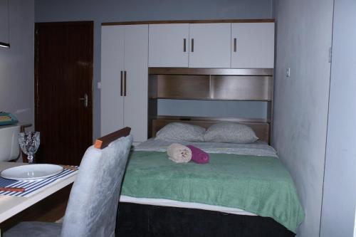 a bedroom with a bed and a table with a sink at Studio11 near Drogasil in Ourinhos