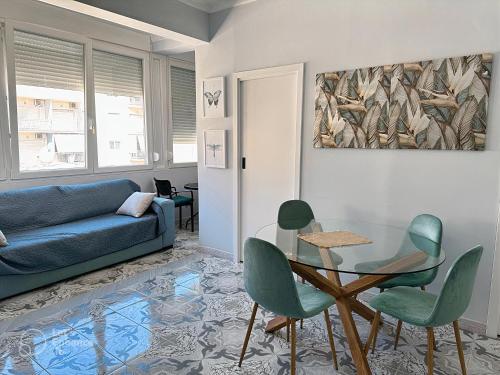a living room with a couch and a table and chairs at ALLO Apartments in Durrës