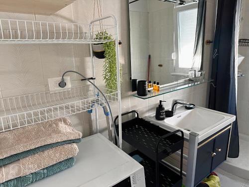 a small bathroom with a sink and a mirror at ALLO Apartments in Durrës