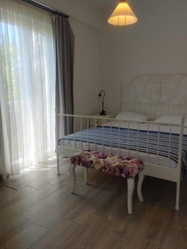 a bedroom with a bed and a lamp and a window at noonbir Alaçatı otel in Alacati