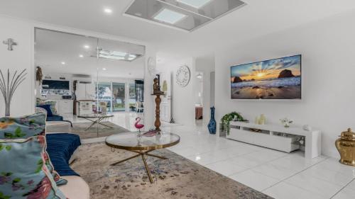 a living room with a couch and a table at The Luxe Waterfront in Sandstone Point