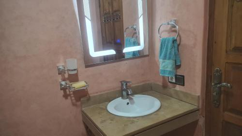 a bathroom with a sink and a mirror at Ouirgane House in Ouirgane
