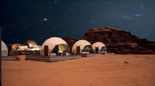 a group of tents in the desert at night at Desert Front camp in Aqaba