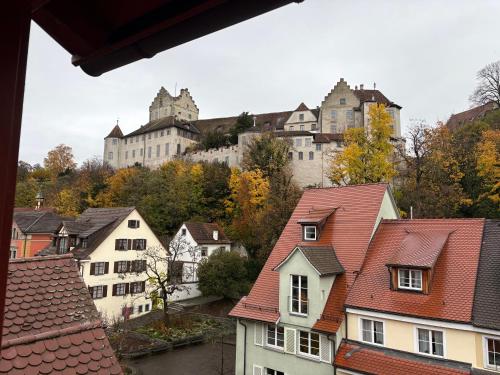 a large castle on top of a hill with houses at Restaurant, Pizzeria " La Taverna " "Hotel Iris" in Meersburg