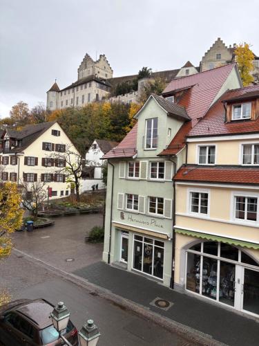 a building with a car parked in a parking lot at Restaurant, Pizzeria " La Taverna " "Hotel Iris" in Meersburg