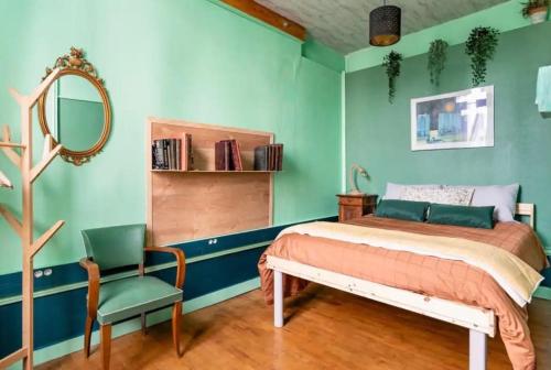 a bedroom with a bed and a mirror and a chair at Le Marmont 3 bedrooms center private parking in Saint-Étienne