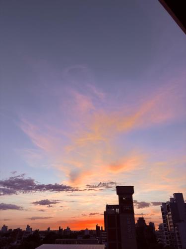 a city skyline with a sunset in the sky at Boulevard Temporario in Santa Fe