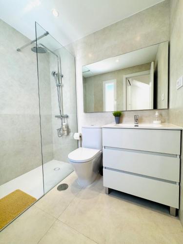 a bathroom with a toilet and a sink and a shower at Bungalow Diana in Maspalomas