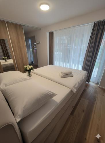 a bedroom with two beds and a large window at Lux Line Apartment in Zürich