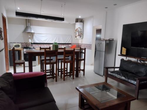 a kitchen and living room with a table and chairs at Qqn planta baja in Quequén