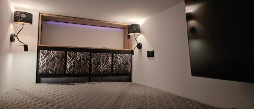 a bedroom with a window and a bed with lights at Apartament centrum - loft Plac Piłsudskiego in Gliwice