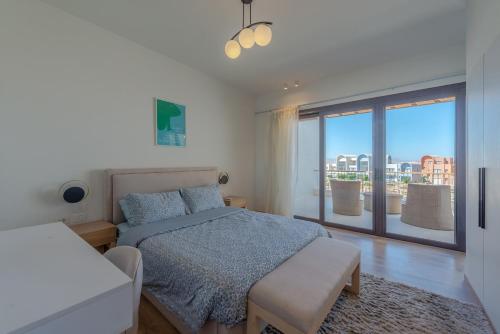 a bedroom with a bed and a large window at Lumina -1 BR Chalet in Kamaran, Gouna in Hurghada