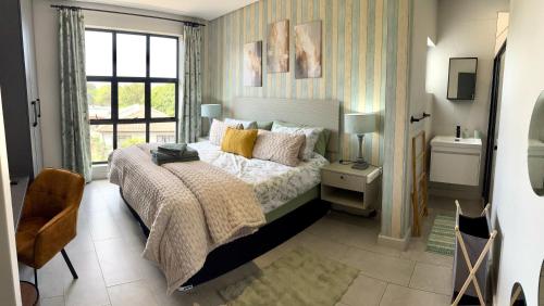 a bedroom with a bed and a window at Table View Escape in Cape Town