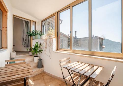 a room with a bench and a table and windows at Norma House on the Rocks in Norma