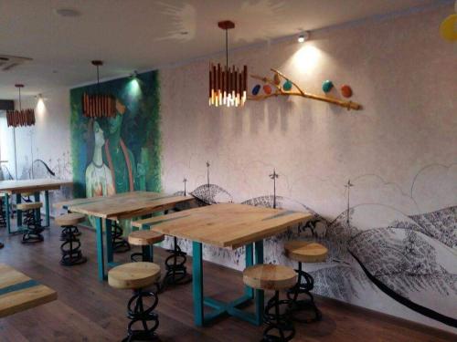 a restaurant with tables and stools in a room at HAPPY NEST home stay valparai in Vālpārai