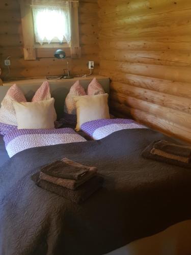 a bedroom with a large bed in a log cabin at Ferienhaus Haigrub in Perasdorf