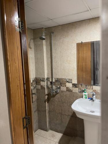 a bathroom with a sink and a shower at The Triple-Bedroom Escape in Rawalpindi