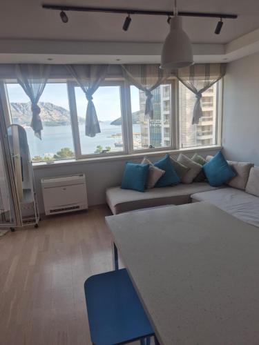 a living room with a couch and a large window at FONTANA FRONT of SEA APARTMENT in Budva